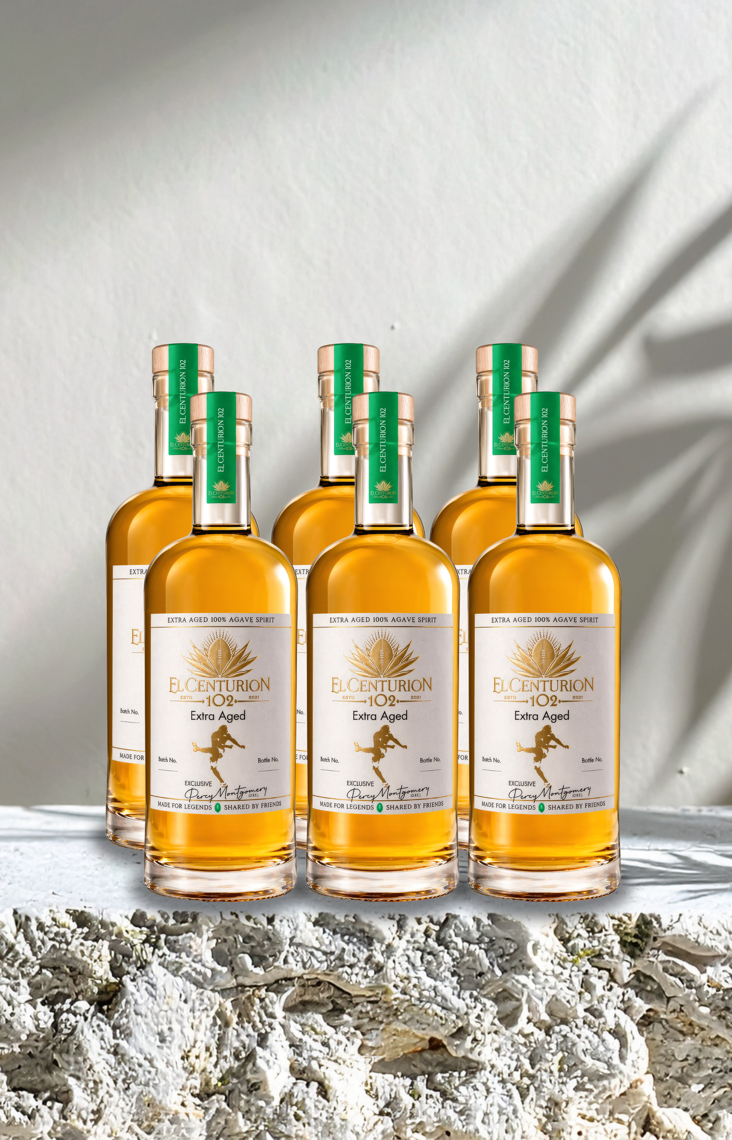 Bottles of El Centurion 102. on a textured surface with a neutral background