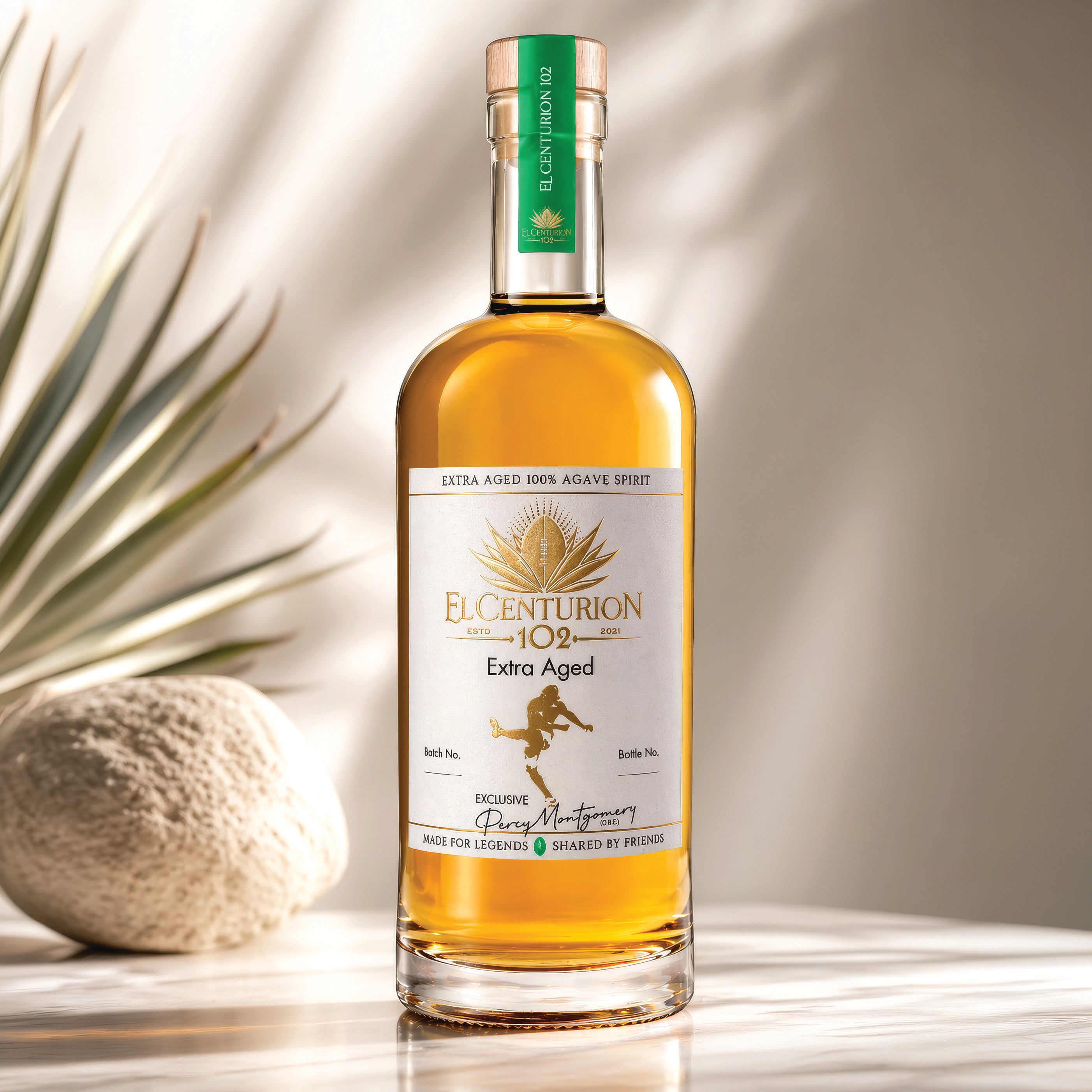 Bottle of El Centurion 102 Extra Aged agave with a plant in the background